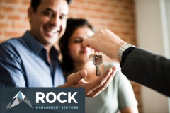 Cheerful couple with keys to their new home