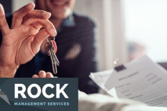 Real estate agent passing keys to his client