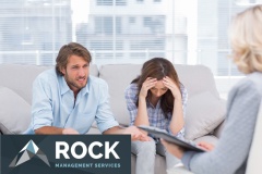 Young couple sit on the couch of the therapist